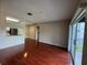 Open living area showcases hard wood floors, lots of light, a kitchen, and access to balcony at 13243 Sanctuary Cove Dr # 204, Temple Terrace, FL 33637