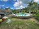 Beautiful pool area with lounge chairs, picnic table, grill, and lush landscaping at 13243 Sanctuary Cove Dr # 204, Temple Terrace, FL 33637