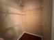 Bright walk-in closet featuring built-in shelving with laminate flooring, maximizing storage and organization at 13243 Sanctuary Cove Dr # 204, Temple Terrace, FL 33637