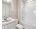 Bright bathroom with shower over bath, white tile, and modern fixtures at 13614 Stevenson Ln, Odessa, FL 33556
