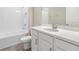 Well-lit bathroom with a combination shower and tub, toilet, and a vanity with ample storage space at 13614 Stevenson Ln, Odessa, FL 33556