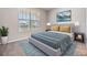 Comfortable bedroom featuring a soft bed, stylish rug and a view of the outside at 13614 Stevenson Ln, Odessa, FL 33556