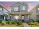 Charming two-story home with a welcoming front porch, landscaped garden and a brick walkway at 13614 Stevenson Ln, Odessa, FL 33556