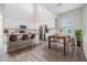 Modern kitchen with large island, bar seating, and stainless steel appliances adjacent to a dining area at 13614 Stevenson Ln, Odessa, FL 33556