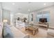 Cozy living room with neutral palette and comfortable seating, open to dining and kitchen at 13614 Stevenson Ln, Odessa, FL 33556