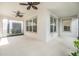 Covered patio with ceiling fans, white walls, and an outside view of the landscape, perfect for entertaining at 13614 Stevenson Ln, Odessa, FL 33556