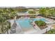 Inviting community pool area with sun loungers and lush tropical landscaping providing a resort-like feel at 13614 Stevenson Ln, Odessa, FL 33556