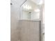 Close-up of a modern shower with tiled walls, glass enclosure, and a rain shower head at 13614 Stevenson Ln, Odessa, FL 33556