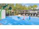 Vibrant splash pad area with interactive water features and shaded seating for relaxation at 13614 Stevenson Ln, Odessa, FL 33556