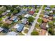 Wide aerial shot of a quiet neighborhood, highlighting a home with mature trees and well-maintained surroundings at 1400 63Rd S Ave, St Petersburg, FL 33705