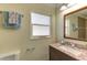 Bathroom featuring granite countertops, modern fixtures, decorative mirror and natural light at 1400 63Rd S Ave, St Petersburg, FL 33705