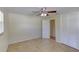 Simple bedroom featuring tile floors, closet, ceiling fan and access to a hall at 1400 63Rd S Ave, St Petersburg, FL 33705