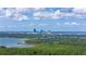 Scenic aerial view of a distant city skyline over a lush, green landscape with a lake in the foreground at 1400 63Rd S Ave, St Petersburg, FL 33705