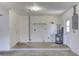 Empty garage featuring concrete floor, open wall space, a water heater, and storage at 1400 63Rd S Ave, St Petersburg, FL 33705