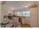 Bright kitchen with white cabinets, granite countertops, stainless steel appliances, and tile flooring at 1400 63Rd S Ave, St Petersburg, FL 33705
