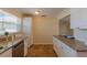 Bright kitchen featuring white cabinets, granite countertops, stainless steel appliances and tile flooring at 1400 63Rd S Ave, St Petersburg, FL 33705