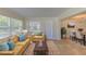 Bright and airy living room virtually staged with a modern sofa and chairs at 1400 63Rd S Ave, St Petersburg, FL 33705