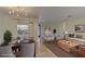 Virtually staged living room with modern furnishings adjacent to dining area and kitchen at 1400 63Rd S Ave, St Petersburg, FL 33705