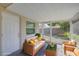 Staged screen enclosed patio with furniture, concrete flooring, and access to backyard at 1400 63Rd S Ave, St Petersburg, FL 33705
