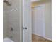 Tiled shower and bathroom with updated shower head and sliding closet doors in the background at 1400 63Rd S Ave, St Petersburg, FL 33705