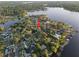 Aerial view of house in a wooded, lakeside community with mature trees and lush greenery at 14825 Lake Magdalene Cir, Tampa, FL 33613