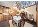 Inviting dining room with a skylight, wood paneling, and elegant furnishings at 14825 Lake Magdalene Cir, Tampa, FL 33613