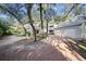 Spacious home featuring a two-car garage, brick driveway, and mature trees at 14825 Lake Magdalene Cir, Tampa, FL 33613