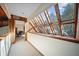 Hallway featuring a wood-accented glass ceiling and access to other rooms at 14825 Lake Magdalene Cir, Tampa, FL 33613