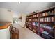 Upstairs hallway with bookshelf, seating, carpet, and natural light from slider in background at 14825 Lake Magdalene Cir, Tampa, FL 33613