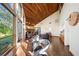 Bright living room featuring stone fireplace, wooden ceiling, and large windows at 14825 Lake Magdalene Cir, Tampa, FL 33613