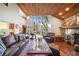 The living room features a stone fireplace, wood ceiling, brick floors, and large window view to the exterior at 14825 Lake Magdalene Cir, Tampa, FL 33613