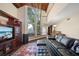 Living room showcasing brick floors, wood ceilings, and large windows providing lots of natural light at 14825 Lake Magdalene Cir, Tampa, FL 33613