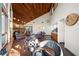 Spacious living room with a fireplace, wooden ceiling, and large windows overlooking the yard at 14825 Lake Magdalene Cir, Tampa, FL 33613