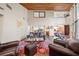 Bright living room with brick flooring, wood ceiling, and multiple views into other living spaces of the home at 14825 Lake Magdalene Cir, Tampa, FL 33613