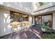 Outdoor patio with a wooden deck and bar seating looking into the house at 14825 Lake Magdalene Cir, Tampa, FL 33613