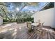 Outdoor patio featuring a wooden deck, table with chairs and a view of the backyard at 14825 Lake Magdalene Cir, Tampa, FL 33613