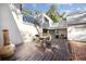 Outdoor patio with wooden deck, a grill and table with chairs offering backyard views at 14825 Lake Magdalene Cir, Tampa, FL 33613