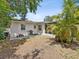 Private backyard featuring a patio with seating, a grill, lush landscaping, and an enclosed patio area at 173 21St Se Ter, Largo, FL 33771