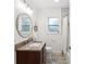 Well-lit bathroom with modern vanity, granite countertop, decorative mirror, and shower with tub combination at 173 21St Se Ter, Largo, FL 33771