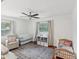 Bright Bedroom featuring a crib, twin bed, and ample storage, bathed in natural light with hardwood flooring at 173 21St Se Ter, Largo, FL 33771