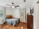 Cozy bedroom with a comfortable bed, hardwood floors, and natural light, complete with window treatments at 173 21St Se Ter, Largo, FL 33771