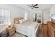Cozy bedroom featuring a woven headboard bed, hardwood floors, and ample natural light at 173 21St Se Ter, Largo, FL 33771