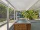 Enclosed sunroom with a jacuzzi, screened windows and views of the surrounding yard at 173 21St Se Ter, Largo, FL 33771