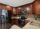 Well-equipped kitchen featuring stainless steel appliances, granite counters, and sleek dark wood cabinets at 173 21St Se Ter, Largo, FL 33771