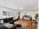 Inviting living room featuring a comfortable dark sofa, wood floors, and ample natural light at 173 21St Se Ter, Largo, FL 33771