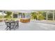 Enclosed sunroom with a hot tub, dining table, screened windows, and views of the surrounding yard at 173 21St Se Ter, Largo, FL 33771