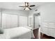 Comfortable bedroom with hardwood floors, bright walls, a ceiling fan, and closet at 2033 Arbor Dr, Clearwater, FL 33760