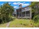 Back of home featuring a screened in porch and garden space at 2033 Arbor Dr, Clearwater, FL 33760
