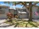 A charming townhome with an attached garage, well-manicured lawn, and mature trees adds to its curb appeal at 2033 Arbor Dr, Clearwater, FL 33760