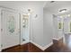 Bright foyer featuring hardwood floors and a white front door with decorative glass at 2033 Arbor Dr, Clearwater, FL 33760